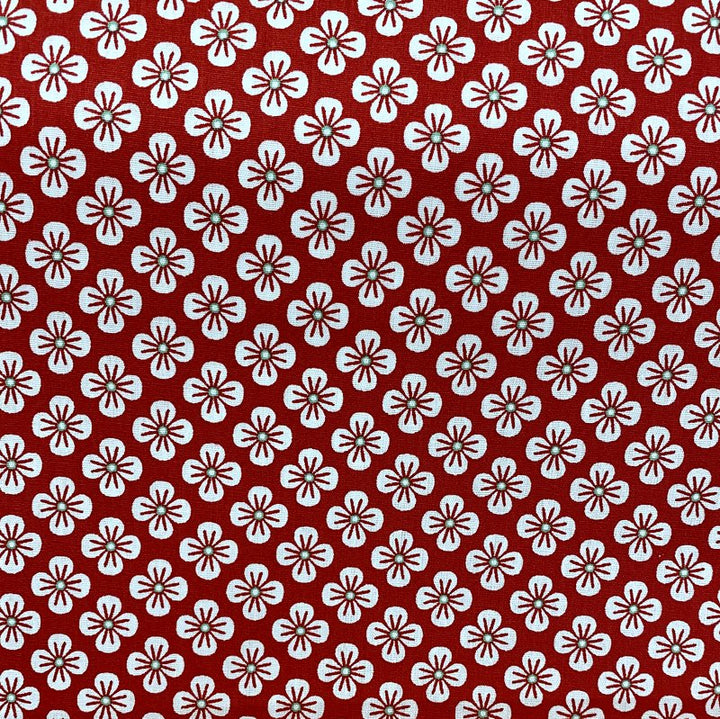 Coton imprimé fleurs blanches fond rouge